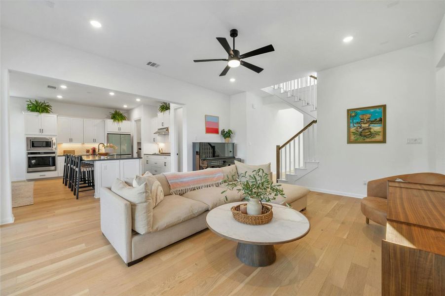 Featuring tall ceilings, LED recessed lighting, modern ceiling fans, and lovely wide plank, light oak wood floors.