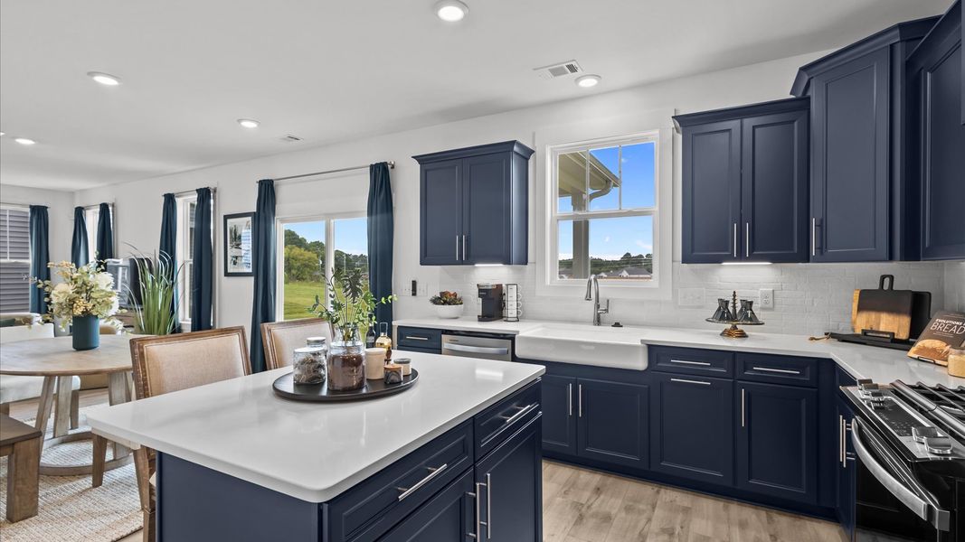 Bright kitchen with stunning decor, quartz countertops, and abundant natural light