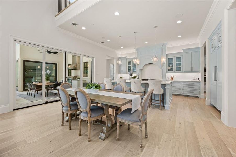 Dining area featuring light wood-style floors, recessed lighting, and crown molding Dining area featuring light wood-style floors, recessed lighting, and crown molding