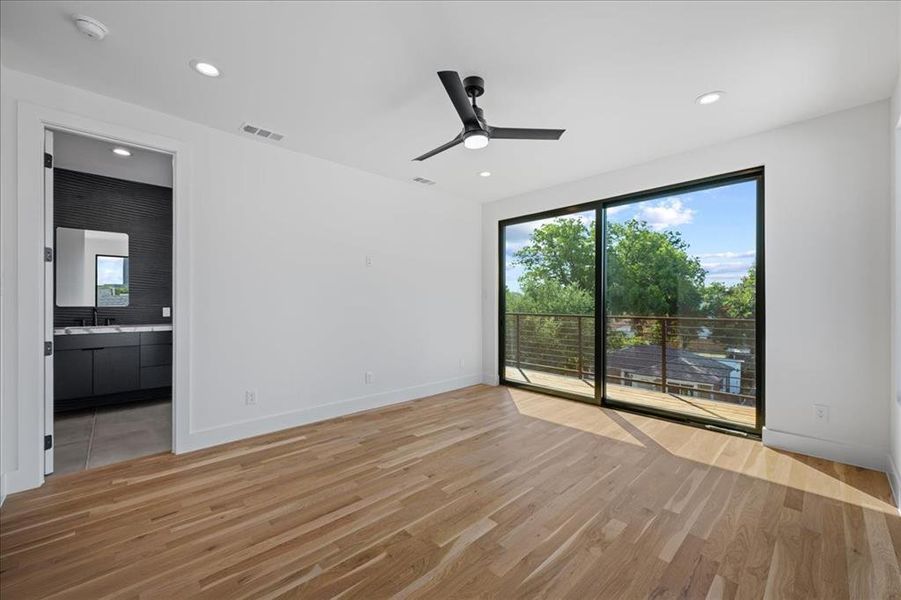 Primary bedroom featuring light wood-style floors, ceiling fan, and recessed lighting Primary bedroom featuring light wood-style floors, ceiling fan, and recessed lighting