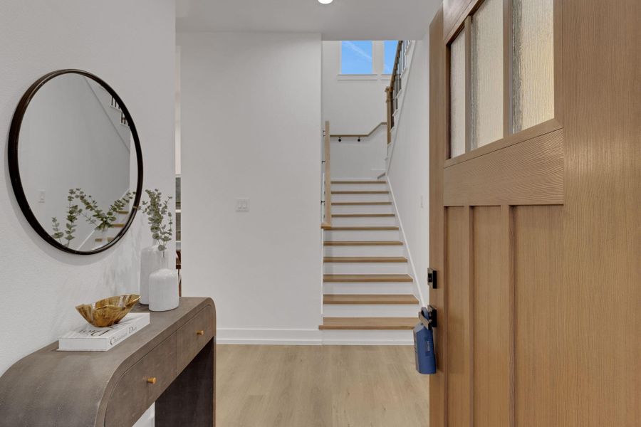 Welcoming foyer with natural wood accents and open staircase leading to the second level. Welcoming foyer with natural wood accents and open staircase leading to the second level.