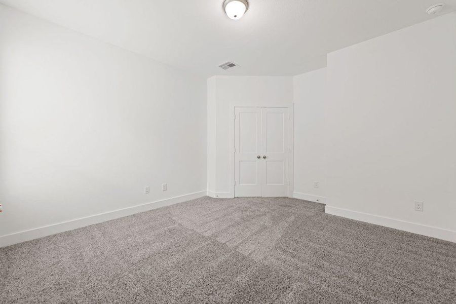 An inviting room boasts fresh carpet and ample closet space, ready for personalization.