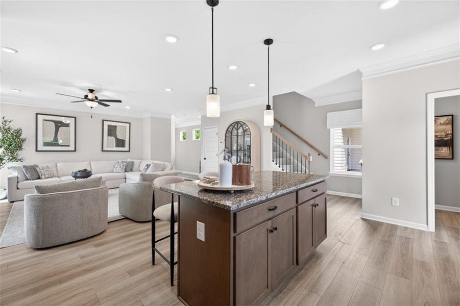 Kitchen island with granite-style countertop and dark wood-finish cabinetry