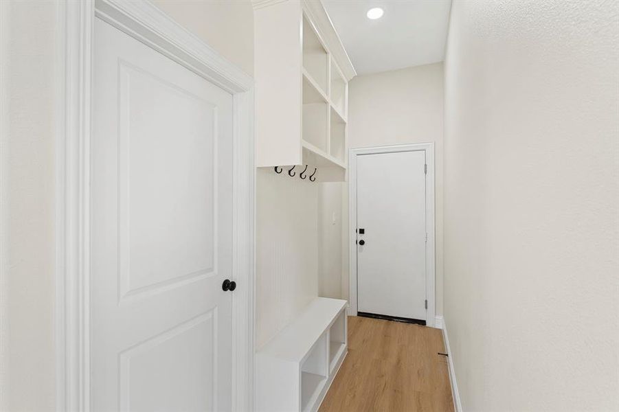 Mudroom with light wood-type flooring and recessed lighting