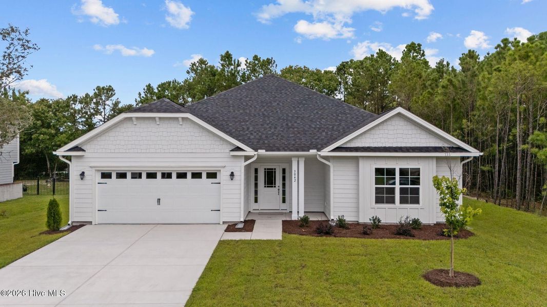 Front exterior of a new home in Wood Creek, Leland, NC, highlighting curb appeal (Image 1). Front exterior of a new home in Wood Creek, Leland, NC, highlighting curb appeal (Image 1).