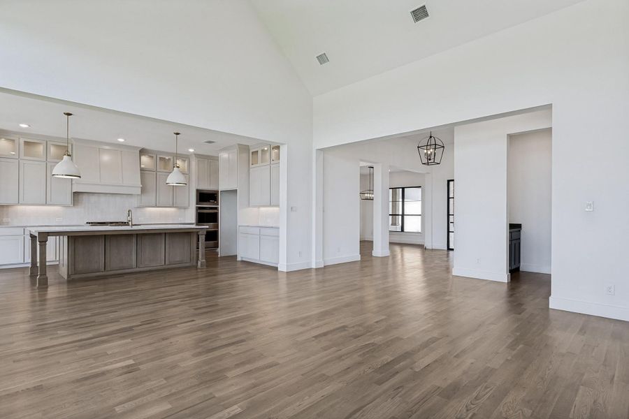 Gleaming hardwood floors flow throughout this grand open space with soaring vaulted ceilings.