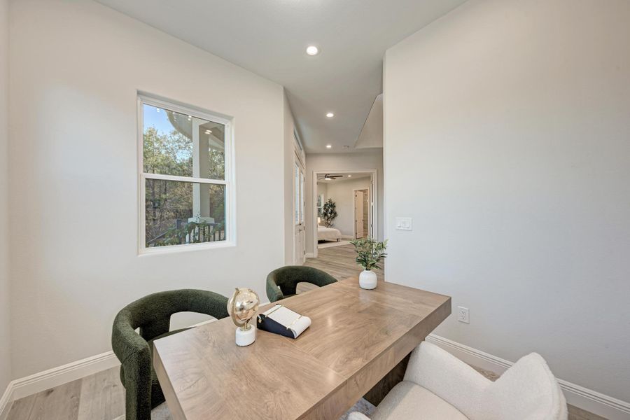 Dining space with light wood-style flooring, recessed lighting, and an office area