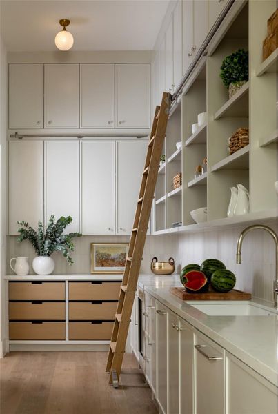 A separate scullery extends the kitchen’s capability with a second sink, dishwasher, beverage fridge, ice maker, coffee maker, microwave, and chilled water dispenser—perfect for entertaining or catering. A separate scullery extends the kitchen’s capability with a second sink, dishwasher, beverage fridge, ice maker, coffee maker, microwave, and chilled water dispenser—perfect for entertaining or catering.