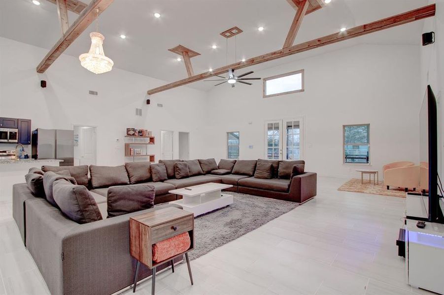 Living area with large sectional for seating and decorative fireplace.