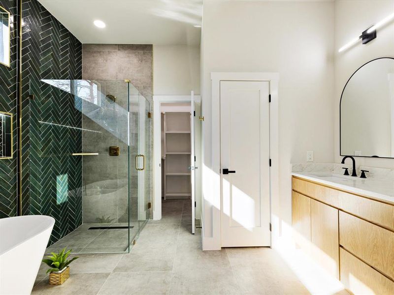 Bathroom featuring vanity, a shower stall, and a freestanding tub