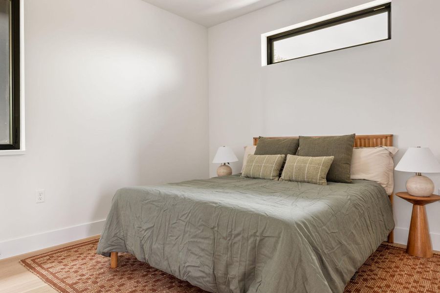 Bedroom with baseboards and wood finished floors Bedroom with baseboards and wood finished floors