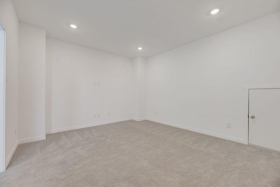 Spare room featuring light colored carpet and recessed lighting