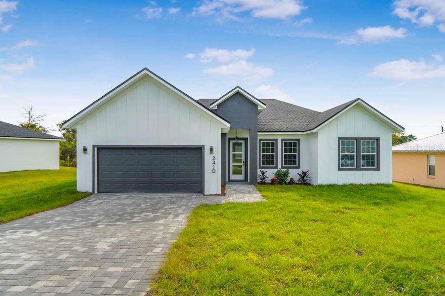 Front exterior of a new home in , Ocala, FL, highlighting curb appeal (Image 1).