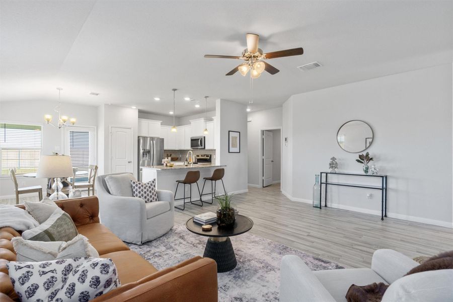 Living room featuring recessed lighting, a chandelier, light wood-style flooring, and ceiling fan