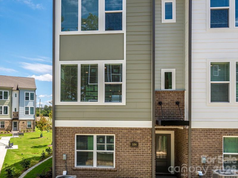 Exterior details and patio area of a home in Central Living at Craig, Charlotte (Image 16).