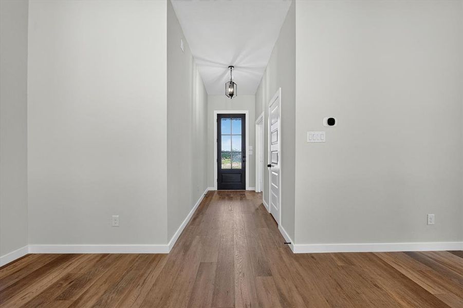 Wood-finish flooring throughout the entryway Wood-finish flooring throughout the entryway