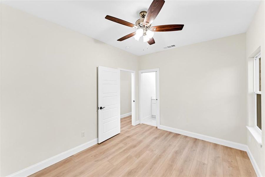 Unfurnished room with ceiling fan and light hardwood / wood-style flooring