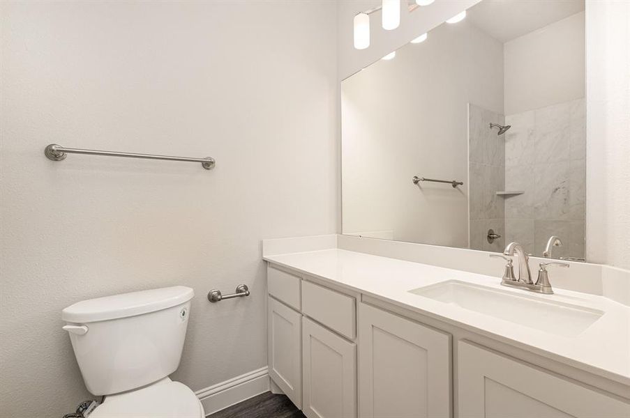 Full bathroom featuring vanity and tiled shower Full bathroom featuring vanity and tiled shower