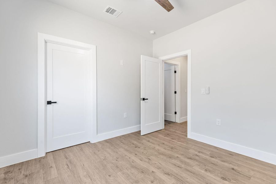 Unfurnished bedroom featuring light wood-style flooring and ceiling fan