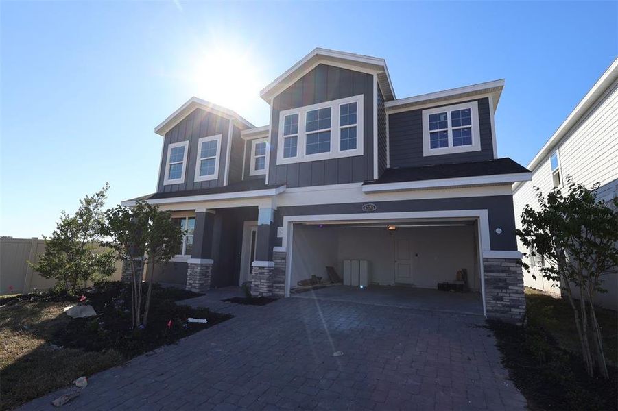 Front exterior of a new home in Center Lake on the Park, St. Cloud, FL, highlighting curb appeal (Image 2). Front exterior of a new home in Center Lake on the Park, St. Cloud, FL, highlighting curb appeal (Image 2).