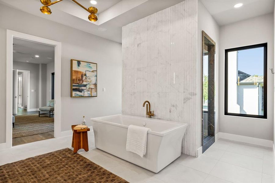 Full bath with a freestanding bath, tile patterned flooring, and recessed lighting Full bath with a freestanding bath, tile patterned flooring, and recessed lighting