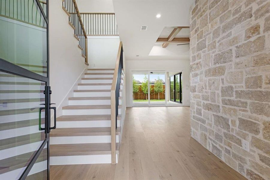 Staircase with beam ceiling and hardwood / wood-style floors