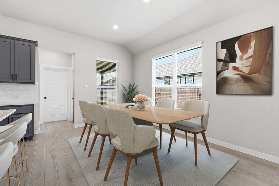Natural light floods this inviting dining space, ideal for memorable gatherings.