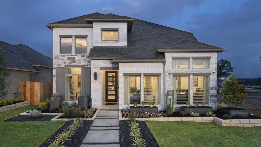 Front exterior of a new home in Grand Central Park, Conroe, TX, highlighting curb appeal (Image 2).