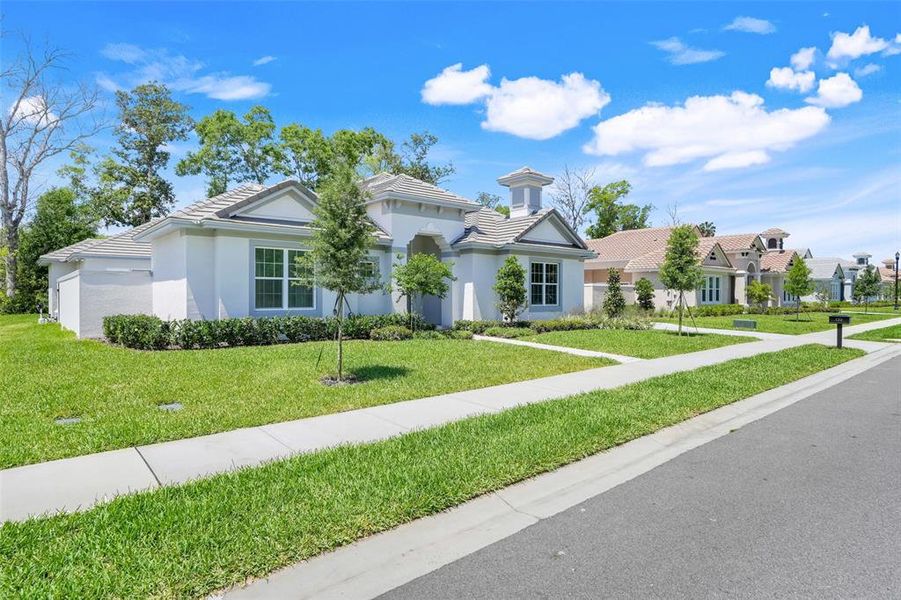 Front exterior of a new home in Toscana, Palm Coast, FL, highlighting curb appeal (Image 25). Front exterior of a new home in Toscana, Palm Coast, FL, highlighting curb appeal (Image 25).