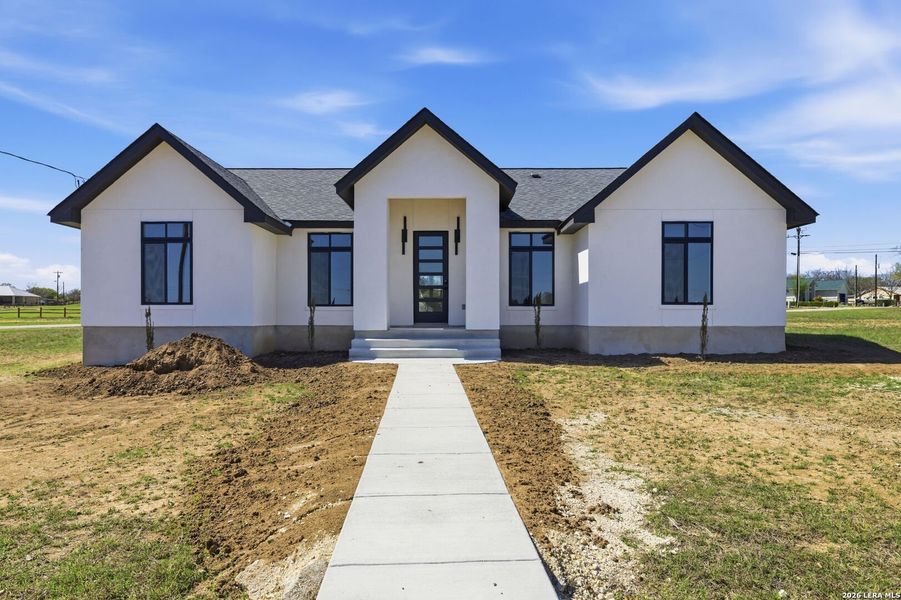 Front exterior of a new home in , Bandera, TX, highlighting curb appeal (Image 26).