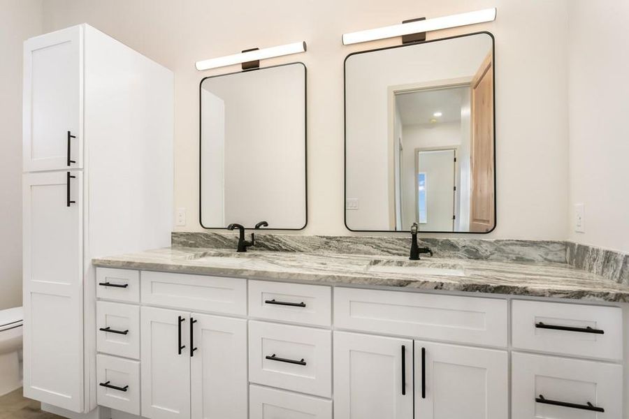 Full bathroom with double vanity and toilet Full bathroom with double vanity and toilet