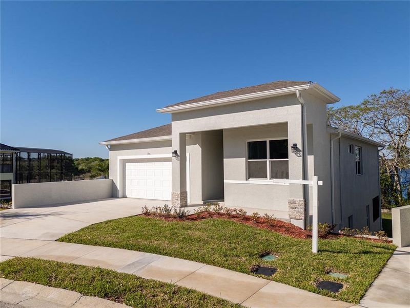 Front exterior of a new home in , Haines City, FL, highlighting curb appeal (Image 2). Front exterior of a new home in , Haines City, FL, highlighting curb appeal (Image 2).