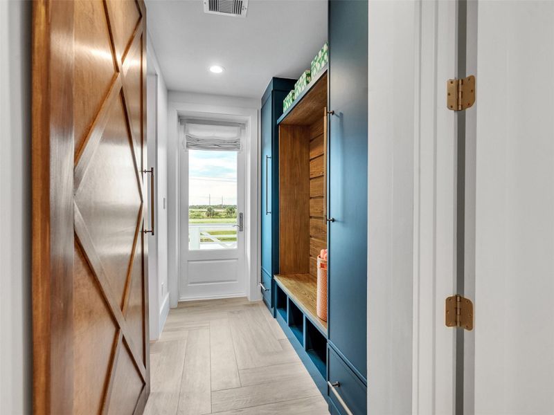 Step inside from the beach and be greeted by a perfectly designed mudroom that blends beauty with practicality. Custom cabinetry offers space to neatly store towels, shoes, and beach gear, keeping the rest of the home spotless and organized. Every detail was crafted for effortless coastal living — hang your hat, drop your bag, and feel instantly at ease as the day’s sand and saltwater stay right where they belong. It’s the kind of entry that makes coming home feel refreshingly simple and stylish. Step inside from the beach and be greeted by a perfectly designed mudroom that blends beauty with practicality. Custom cabinetry offers space to neatly store towels, shoes, and beach gear, keeping the rest of the home spotless and organized. Every detail was crafted for effortless coastal living — hang your hat, drop your bag, and feel instantly at ease as the day’s sand and saltwater stay right where they belong. It’s the kind of entry that makes coming home feel refreshingly simple and stylish.