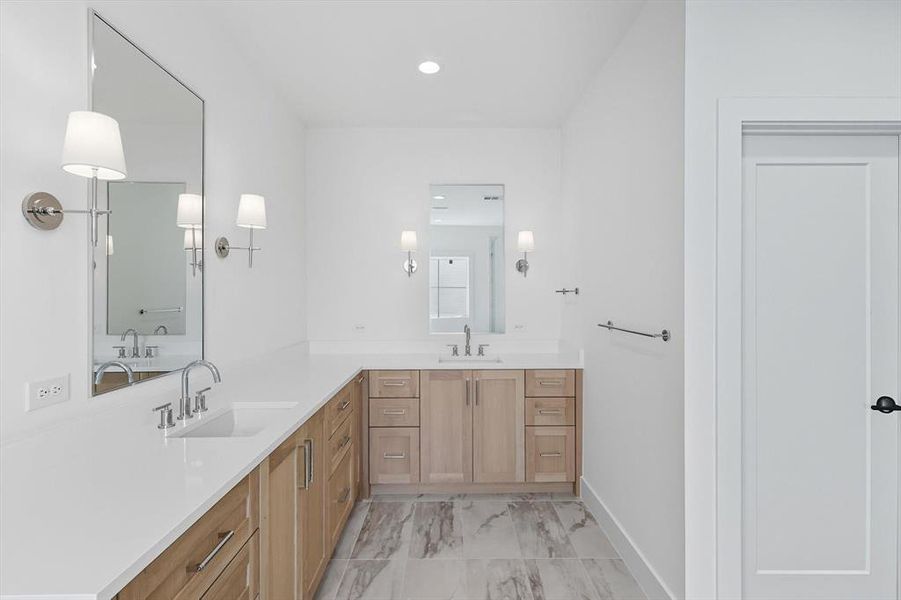 Bathroom featuring double vanity, recessed lighting, and light marble finish floors Bathroom featuring double vanity, recessed lighting, and light marble finish floors