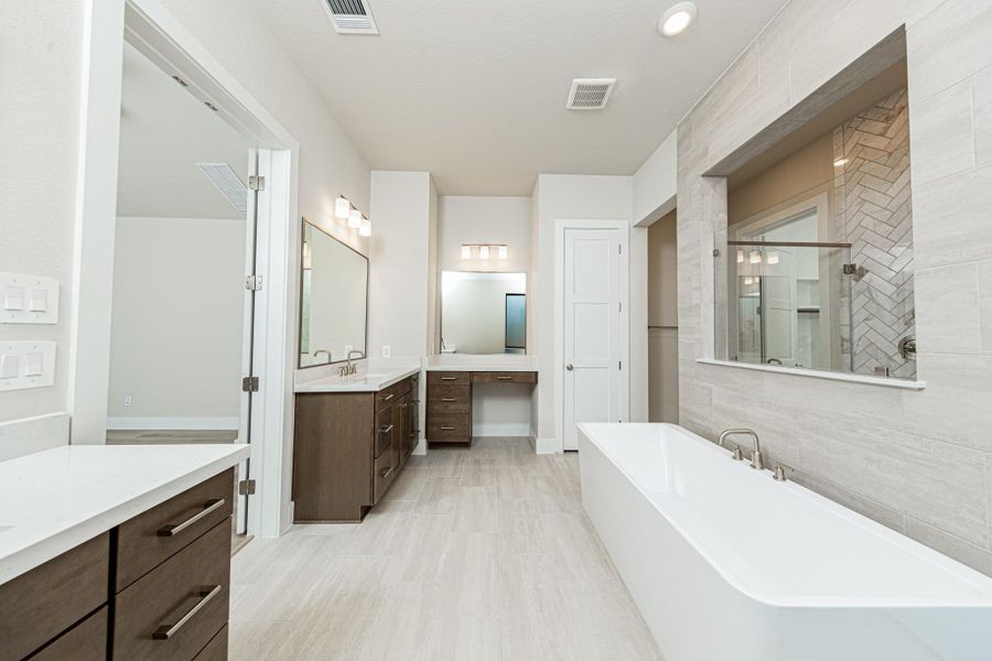 Additional view of dual vanities which also includes another vanity with knee space, allowing for a comfortable, seated grooming experience.