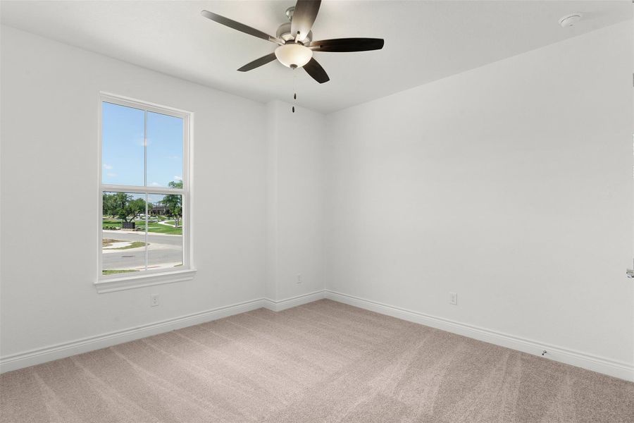 Neutral paint tones complement the carpeted flooring and white trim