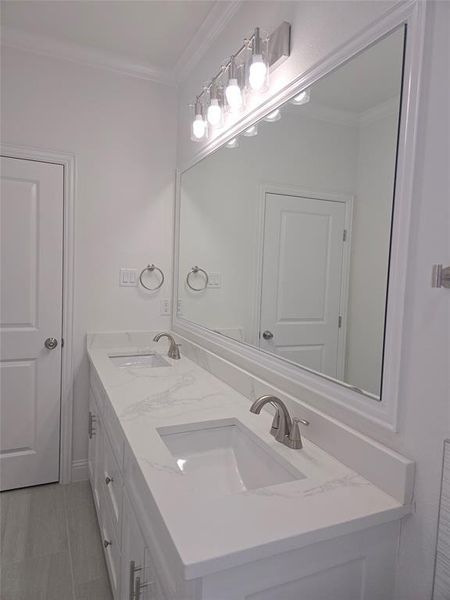 Full bathroom with ornamental molding and double vanity Full bathroom with ornamental molding and double vanity