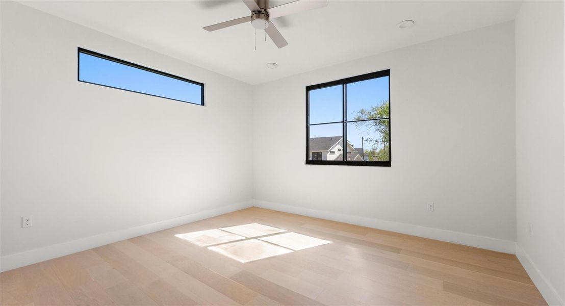 Spare room with light wood-type flooring and ceiling fan