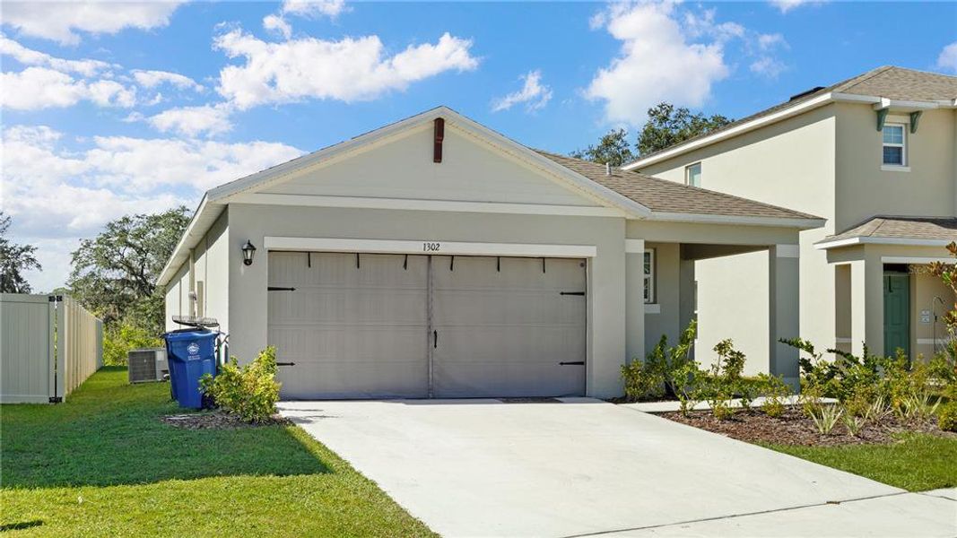 Front exterior of a new home in Charles Cove Express, Davenport, FL, highlighting curb appeal (Image 2).