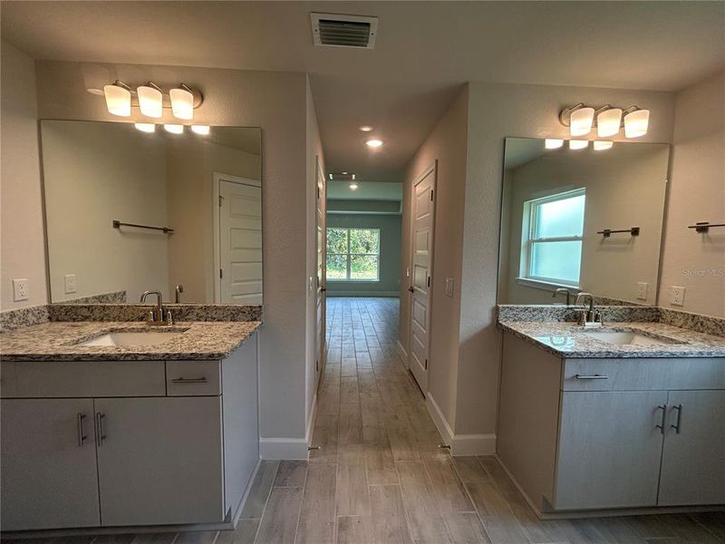 Dual Vanities in the Primary Bathroom with 3 cm Granite Countertops Dual Vanities in the Primary Bathroom with 3 cm Granite Countertops