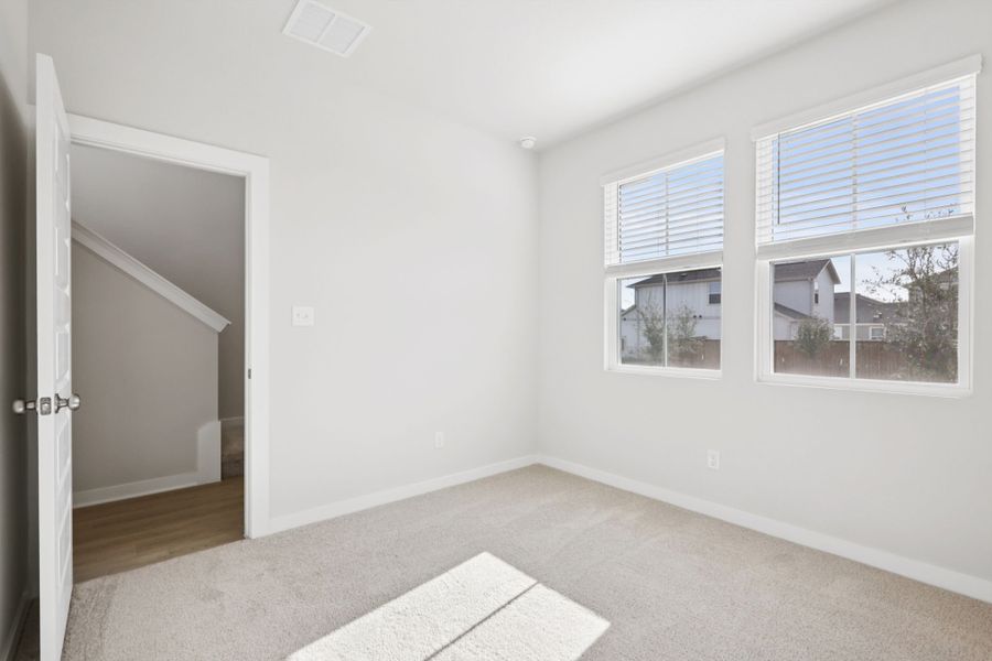 A room with a rug and a door.