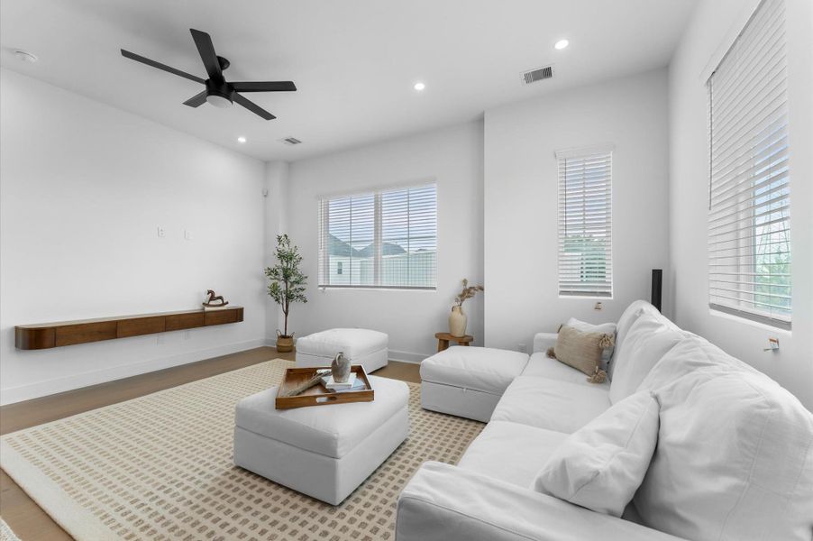 The second floor boasts a spacious open-concept living, dining, and kitchen area filled with natural light from abundant windows, featuring sleek modern finishes and warm engineered hardwood floors that create the perfect blend of style and comfort for everyday living and entertaining. The second floor boasts a spacious open-concept living, dining, and kitchen area filled with natural light from abundant windows, featuring sleek modern finishes and warm engineered hardwood floors that create the perfect blend of style and comfort for everyday living and entertaining.