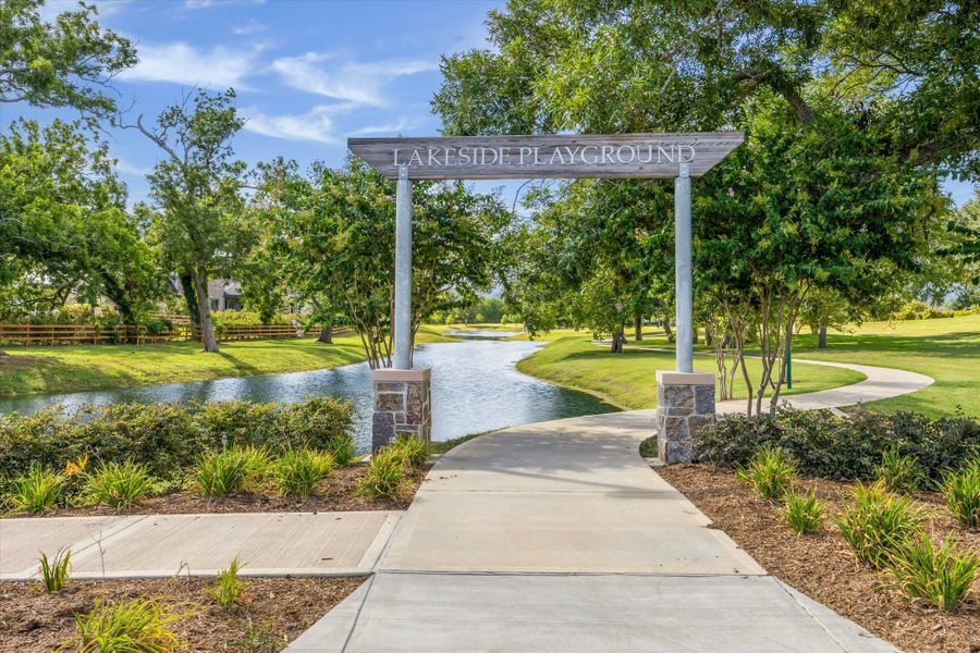 Lakeside Playground entry welcomes you with winding trails, lush landscaping, and peaceful water views just beyond. A scenic setting designed for outdoor play, strolls, and relaxed afternoons under the trees. Lakeside Playground entry welcomes you with winding trails, lush landscaping, and peaceful water views just beyond. A scenic setting designed for outdoor play, strolls, and relaxed afternoons under the trees.