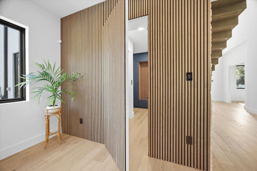 What appears as a sculptural design element subtly transforms—revealing a concealed entry crafted for both discretion and style.