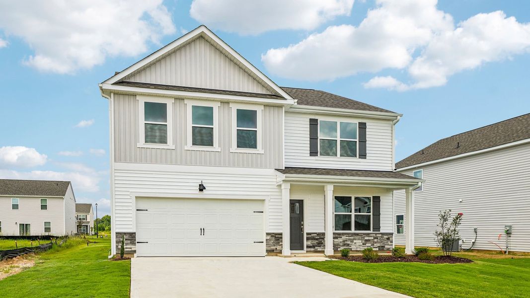 Front exterior of a new home in Shahbain Reserve, Raeford, NC, highlighting curb appeal (Image 17). Front exterior of a new home in Shahbain Reserve, Raeford, NC, highlighting curb appeal (Image 17).