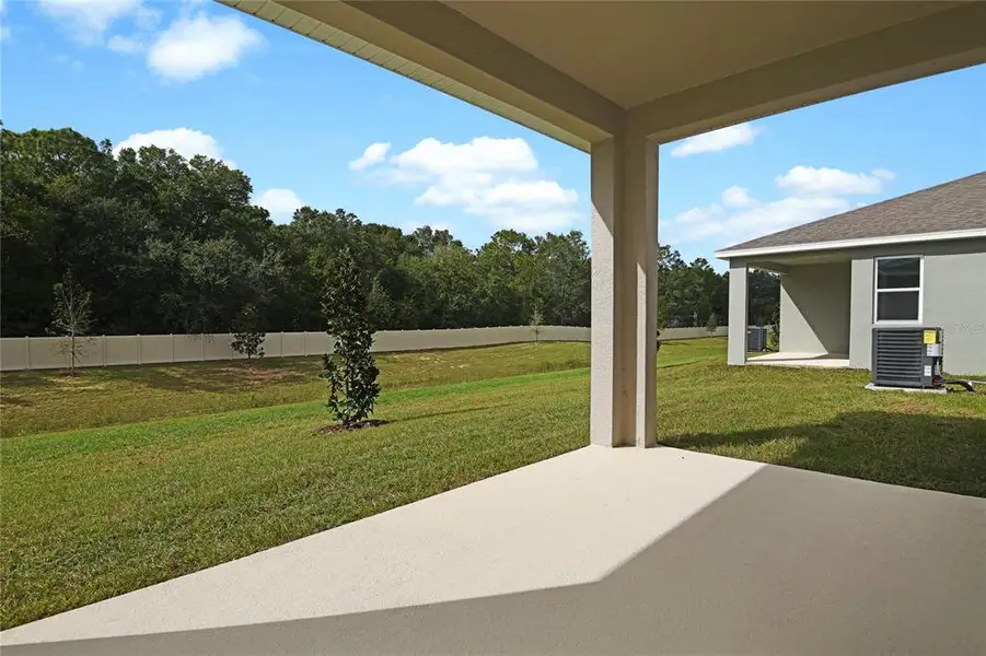 Exterior details and patio area of a home in Seasons at Aurora Oaks, Ocala (Image 3).