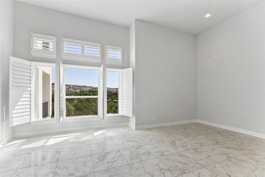 A well-lit room showcasing a serene landscape beyond multiple windows.