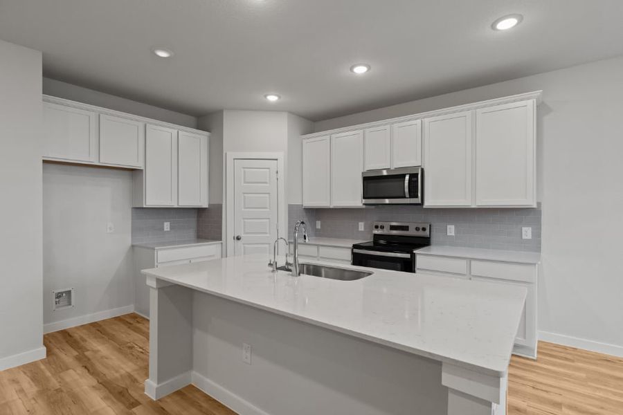 A kitchen with white cabinets. A kitchen with white cabinets.