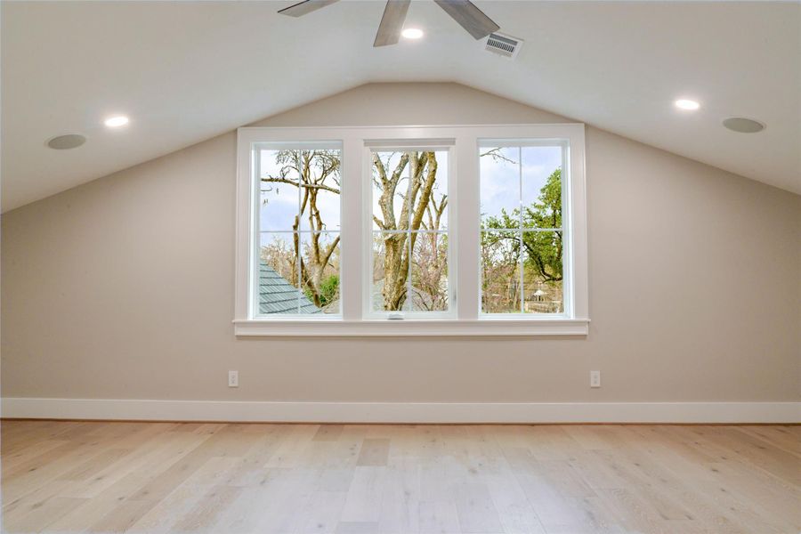 Additional living space featuring light wood-style floors, recessed lighting, and a ceiling fan
