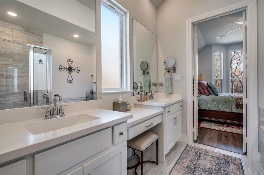 Full bath featuring vanity, a stall shower, ensuite bathroom, light wood-style flooring, and recessed lighting
